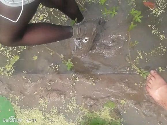 和穿着黑丝白袜帆布鞋的妹子在一片水塘里玩水