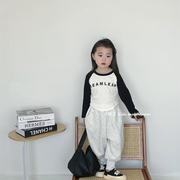 儿童黑色长袖插肩袖T恤2024春季韩版男女童字母印花圆领上衣